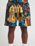 Colorful shorts with a tropical design featuring people and nature on a white background